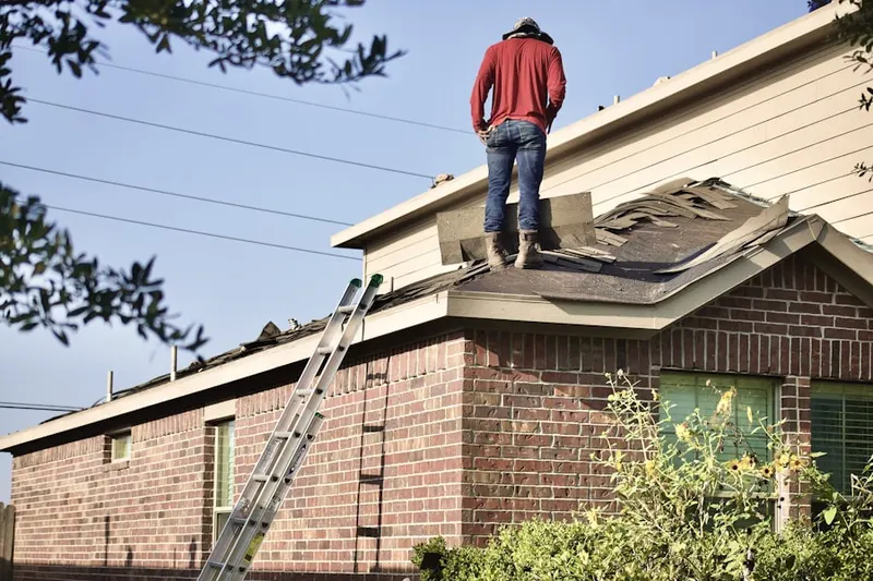 Professional roofer working on a residential roof in Galaxie